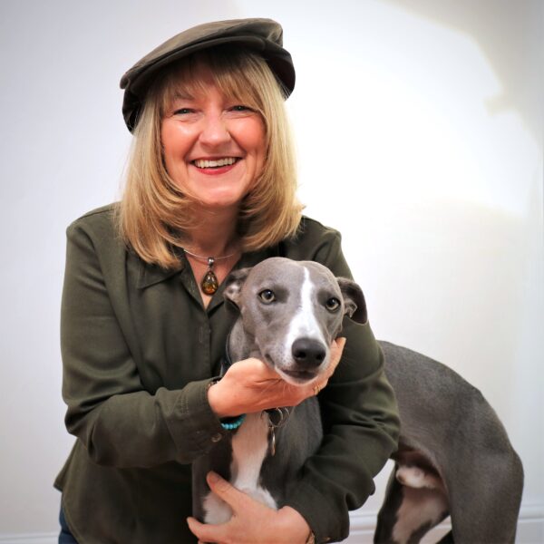 Sara Starling voice over in a flat cap, with her whippet pup Neville Longbottom beside her, inspiring her Northern accent reel.